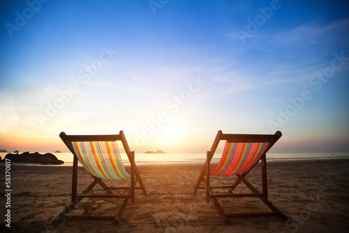 Pair of beach loungers on the deserted coast sea. © De Visu