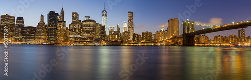 Manhattan skyline with Brooklyn Bridge at dusk