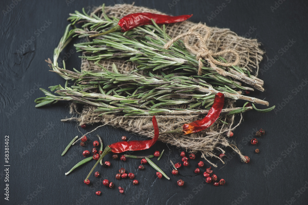 Herbs and spices: rosemary and variety of pepper