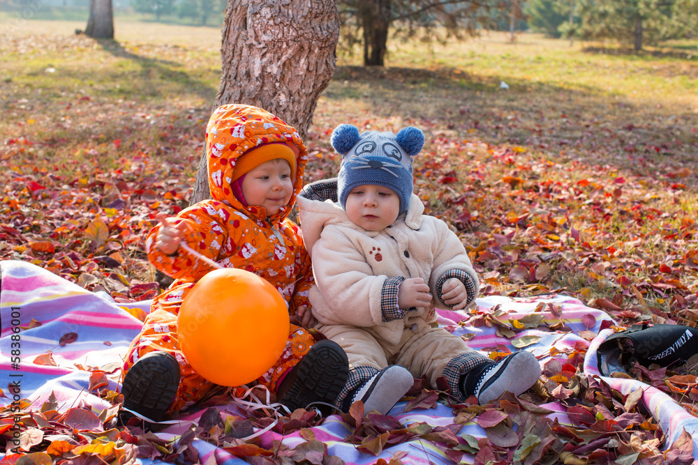 Happy child boy and girl playing with leaves in autumn park Happy child boy and girl playing with leaves in autumn park