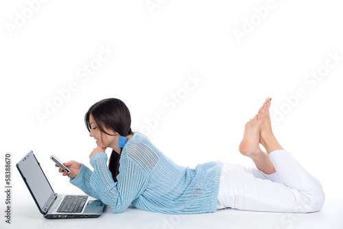 Lying girl with mobile phone and laptop