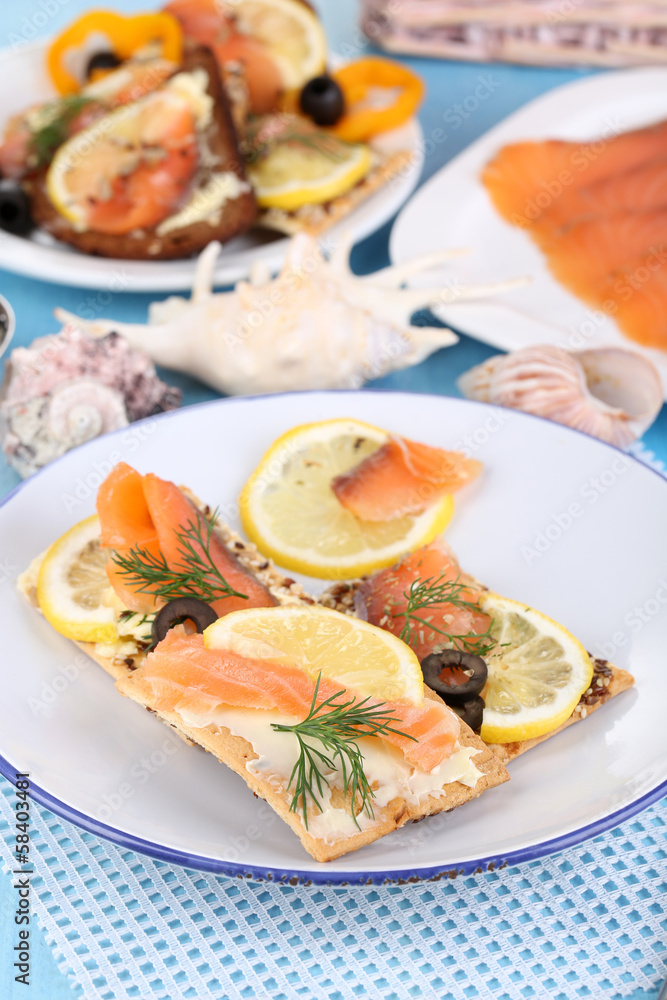 Salmon sandwiches on plate on wooden table close-up Salmon sandwiches on plate on wooden table close-up