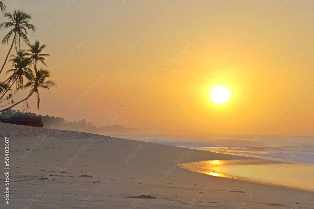 Romantic sunrise on tropical beach
