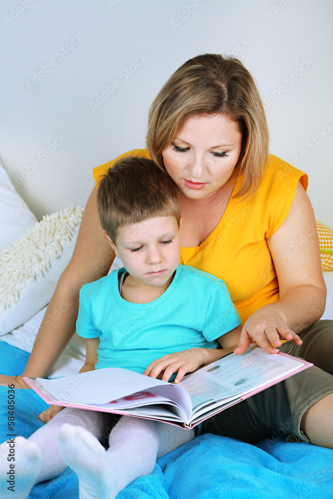 Little boy with mom read book in bed Little boy with mom read book in bed