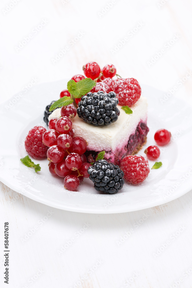 piece of cake with fresh berries, vertical piece of cake with fresh berries, vertical