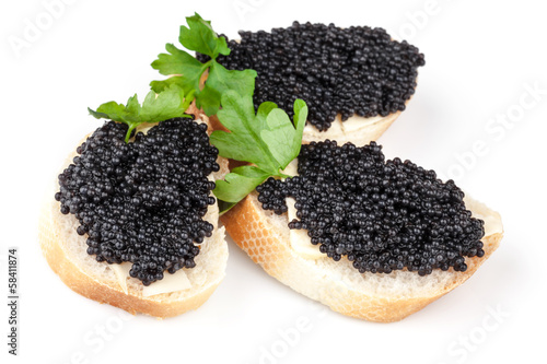 Three sandwiches with black caviar isolated on white background