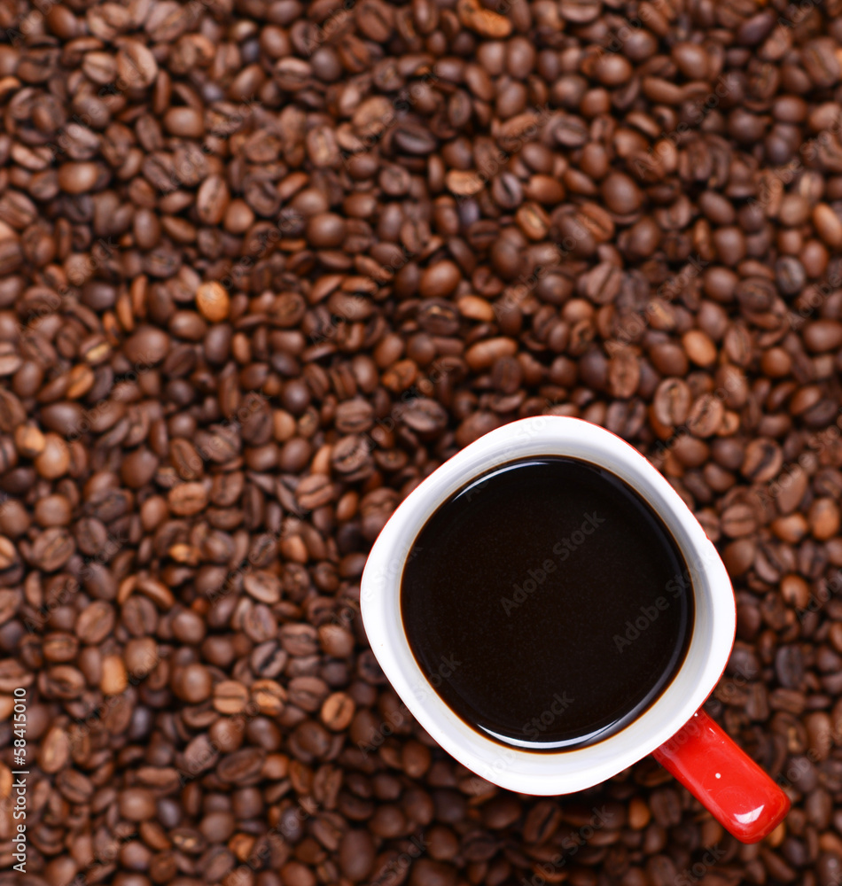 Cup of coffee on coffee beans background Cup of coffee on coffee beans background