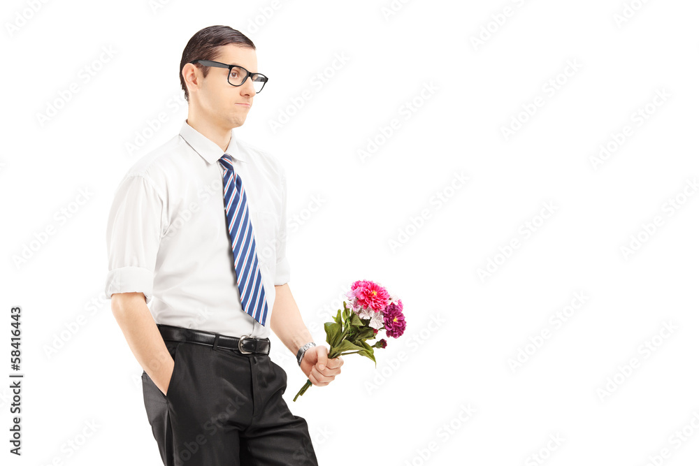 Worried young man with tie holding a bouquet of flowers Worried young man with tie holding a bouquet of flowers