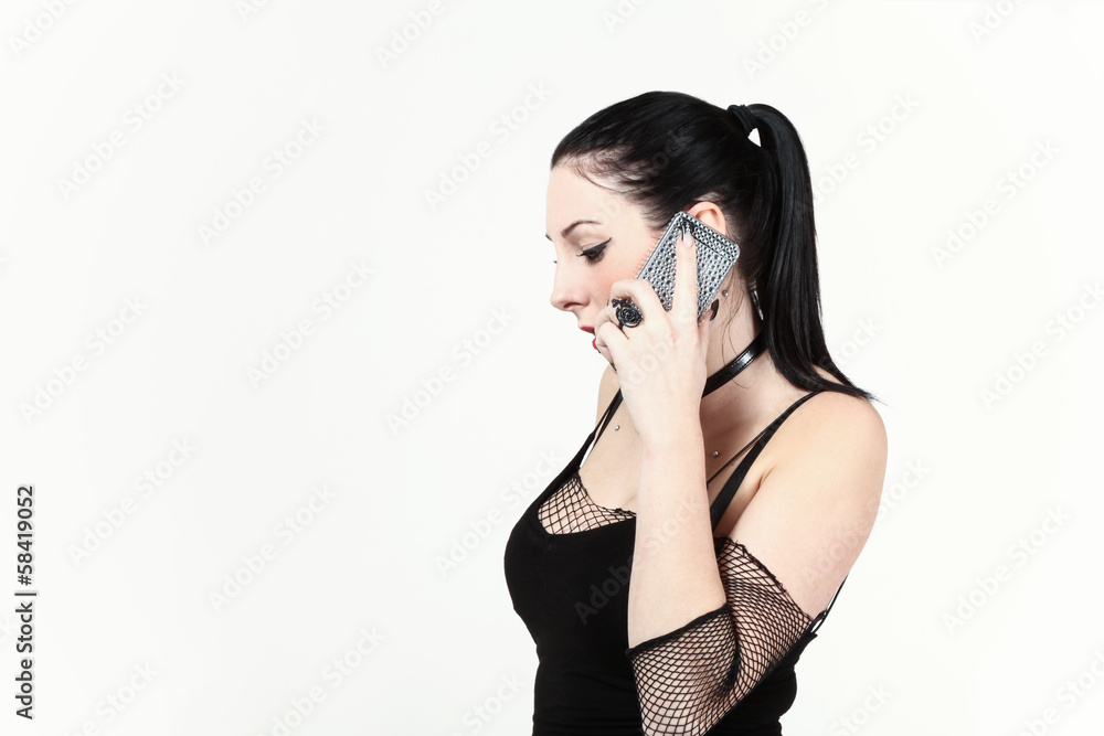 beautiful girl is on the phone, portrait in studio beautiful girl is on the phone, portrait in studio