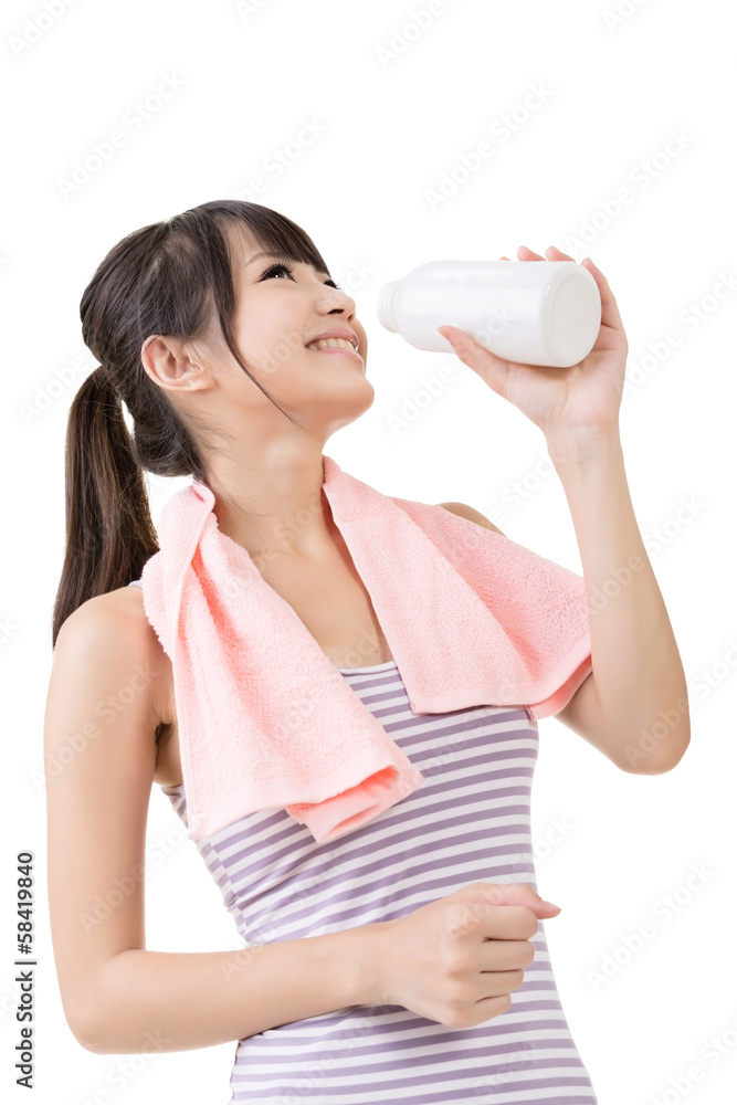 Sporty asian woman drinking water from a bottle Sporty asian woman drinking water from a bottle