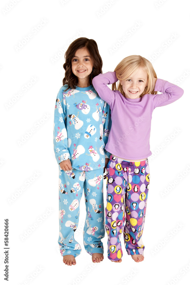 Young girls wearing winter christmas pajamas smiling Young girls wearing winter christmas pajamas smiling