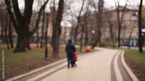 Wallpaper Mural A woman with a baby carriage in the autumn park. Blurred Torontodigital.ca