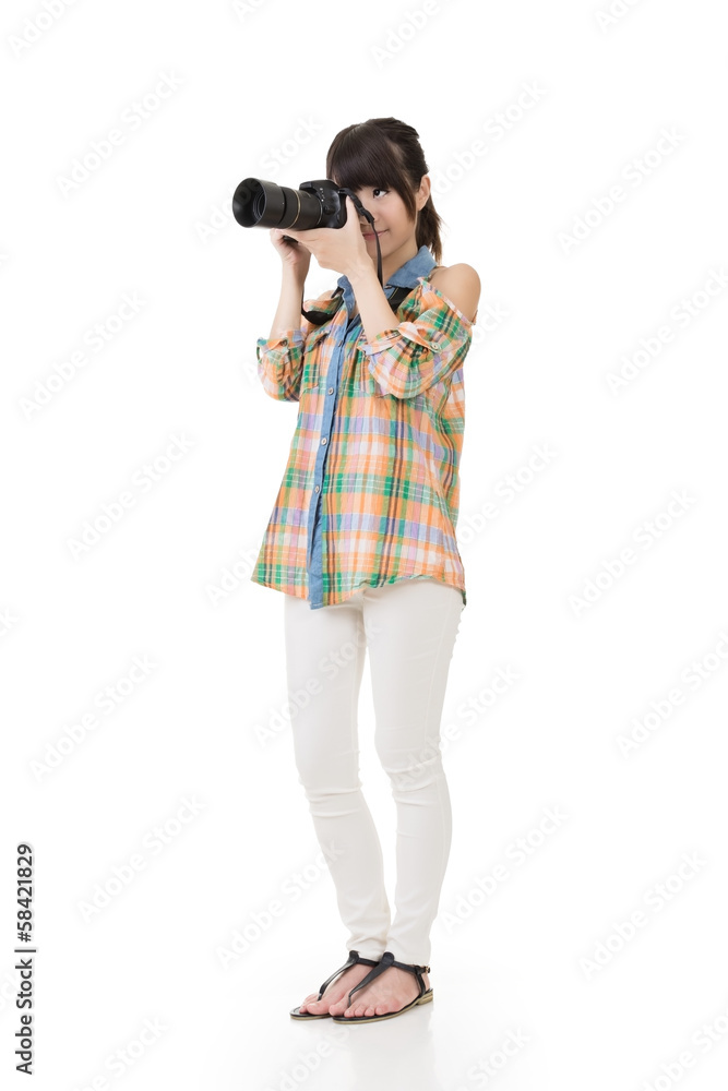 Asian woman takes pictures with photo camera