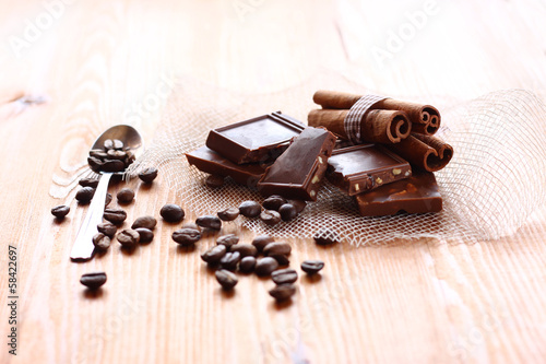 chocolate, cinamon and coffee beans on wooden table
