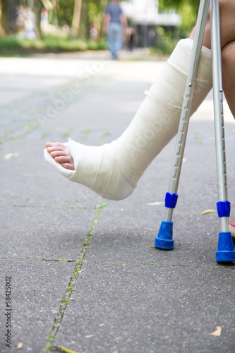 Young girl with broken leg on crutches