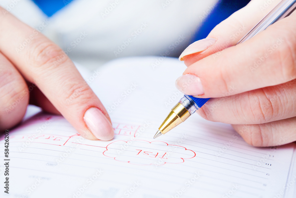 Business Woman Writing with pen in notepad Business Woman Writing with pen in notepad