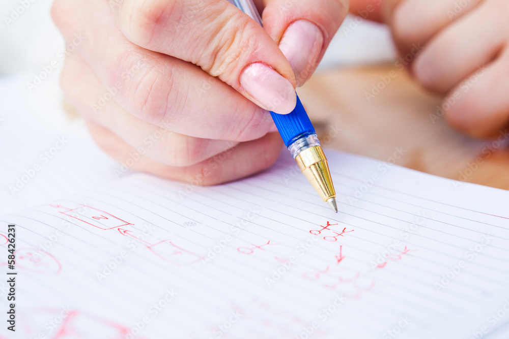 Business Woman Writing with pen in notepad Business Woman Writing with pen in notepad