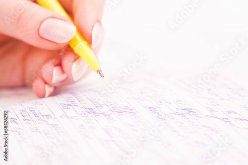 Business Woman Writing with pen in notepad