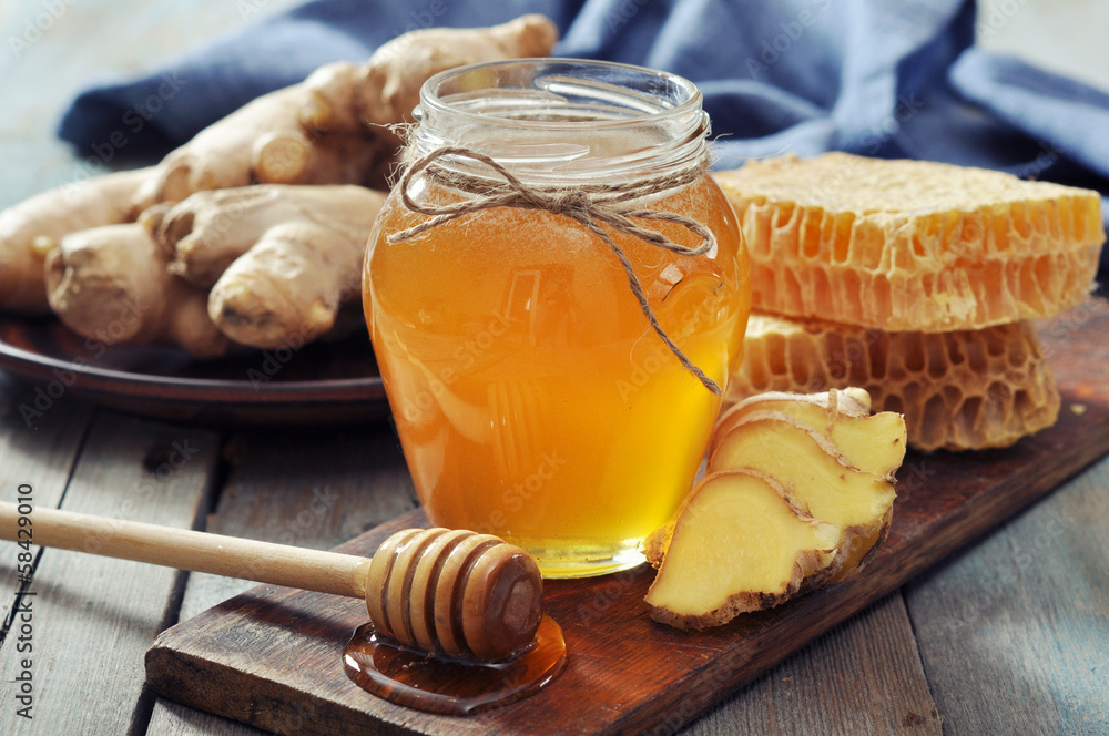 Honey in jar with fresh ginger Honey in jar with fresh ginger