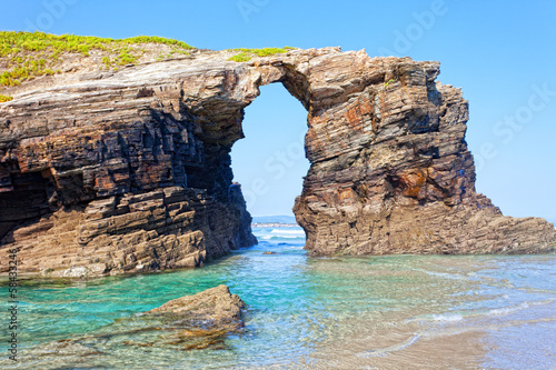Stone arches on Playa de las Catedrales during outflow, Spain