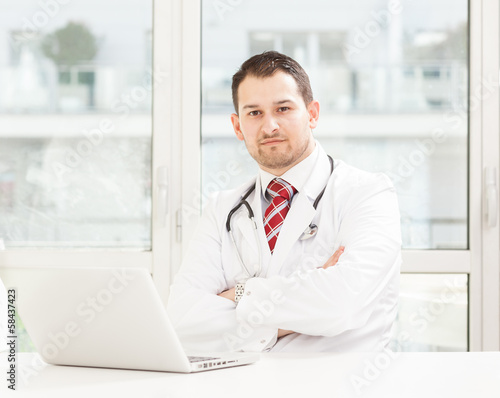 Young male doctor working in his studio