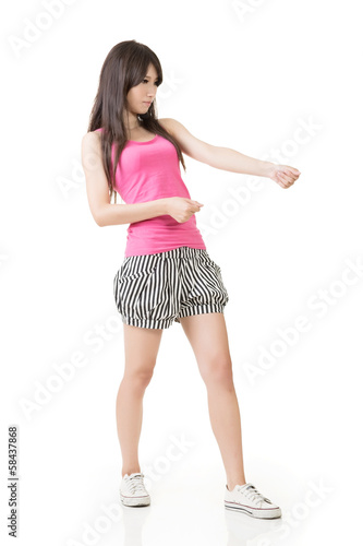 Young asian woman pulls an imaginary rope