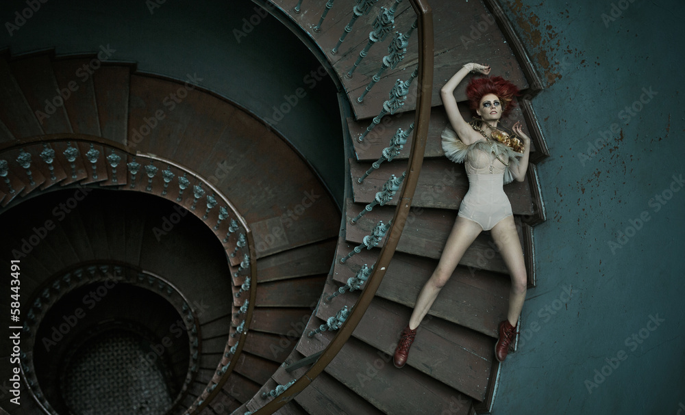 Fototapeta premium Art picture of woman falling on the stairs