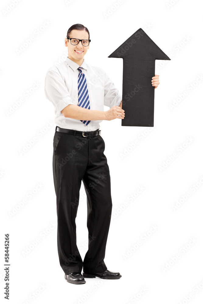 Smiling man with glasses holding a big black arrow pointing up Smiling man with glasses holding a big black arrow pointing up
