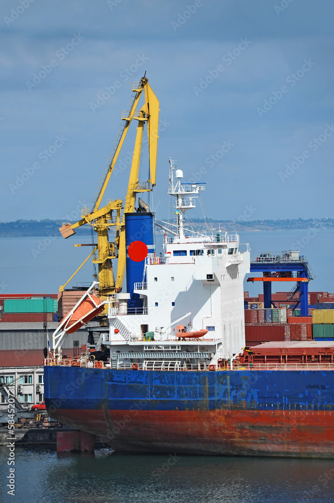 Naklejka premium Bulk cargo ship under port crane bridge, Odessa, Ukraine