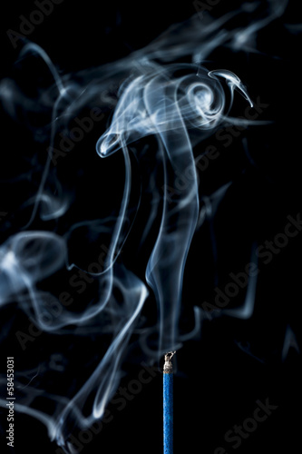 smoke from the incense stick on black background