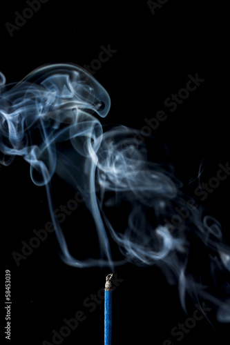 smoke from the incense stick on black background