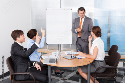 Businesspeople Asking Question To Businessman