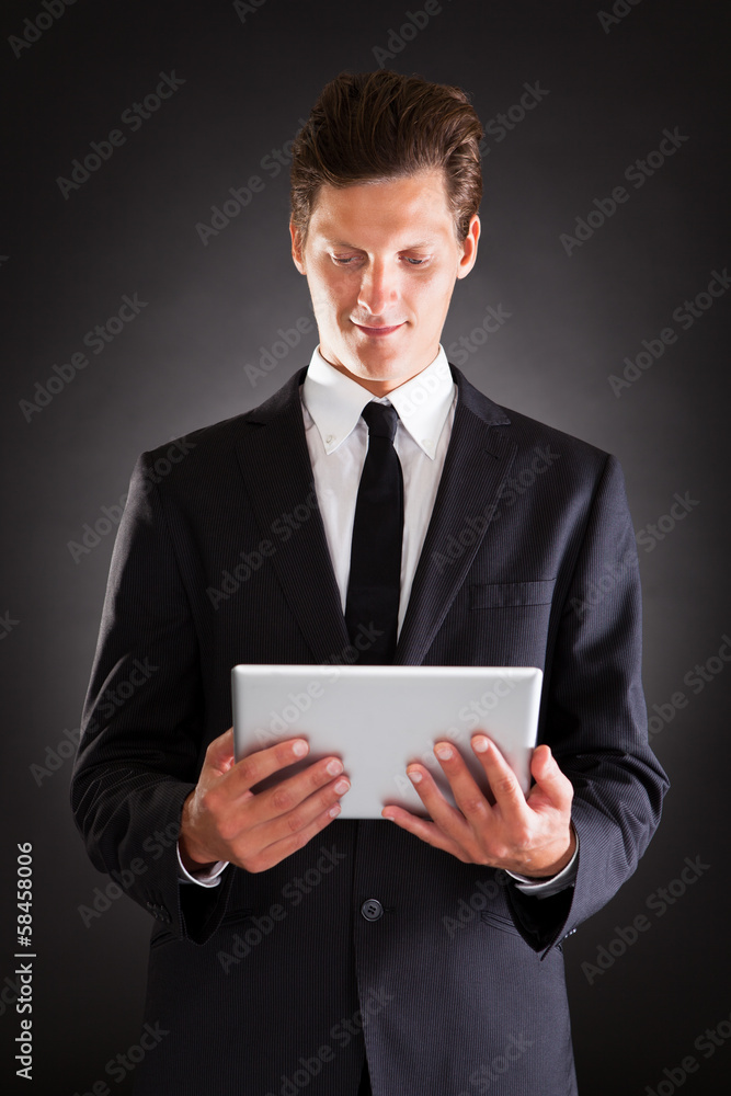 Young Businessman Using At Digital Tablet Young Businessman Using At Digital Tablet