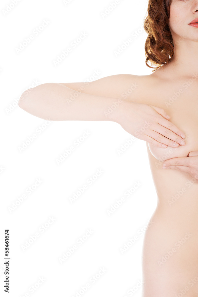 Obraz premium Young woman examining her breast for signs of breast cancer