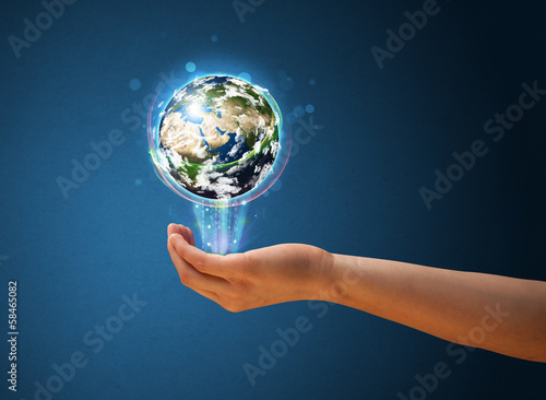 Woman holding a glowing earth globe