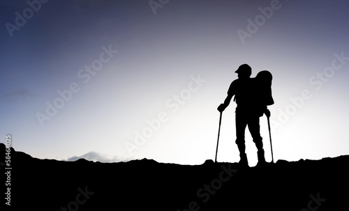 Silhouette of a tourist on the mountain top.