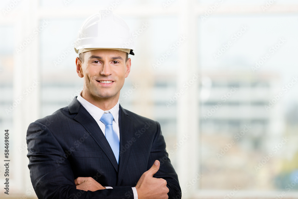 Portrait of engineer in hard hat with his arms crossed Portrait of engineer in hard hat with his arms crossed