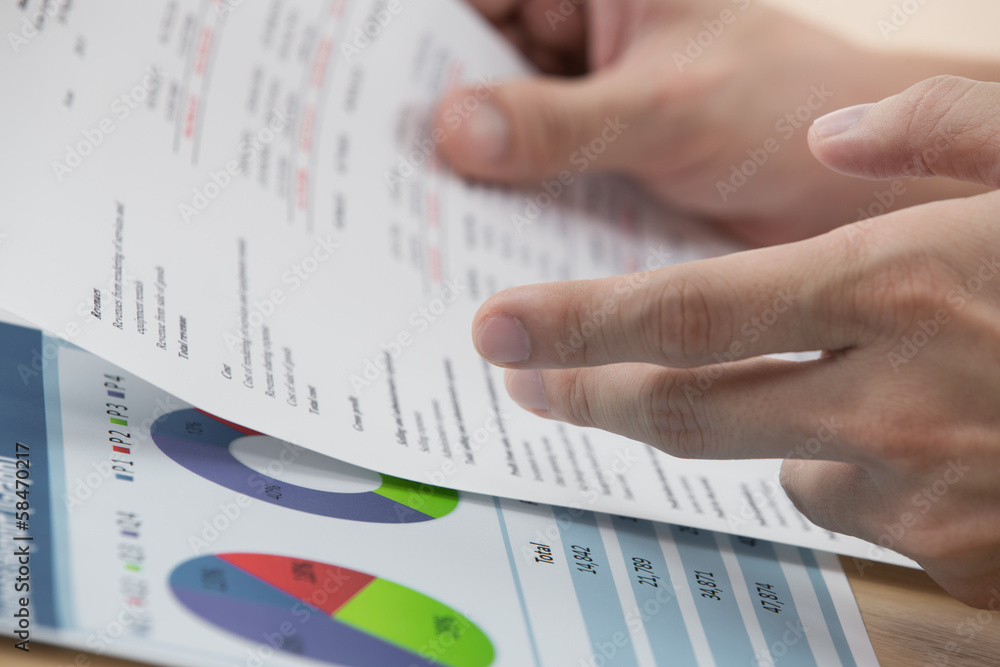 man hand with business report man hand with business report
