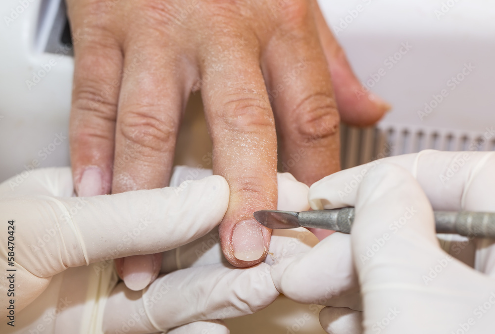 Obraz premium processes work on a manicure in the salon
