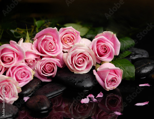 Still life with branch rose with black stones