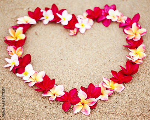 Flower love symbol on sand