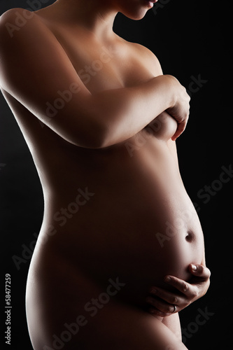 Naked Pregnant Woman/Nude pregnant woman. Low key studio photogr