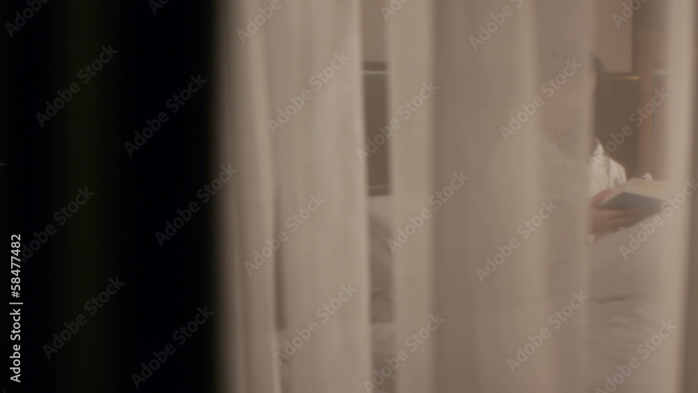 beautiful brunette reading a book in bed slider dolly shot beautiful brunette reading a book in bed slider dolly shot