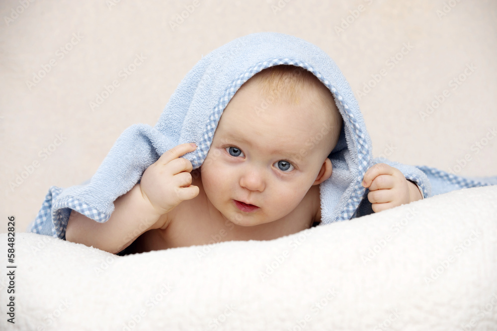 Baby looking at the camera on a peach background Baby looking at the camera on a peach background