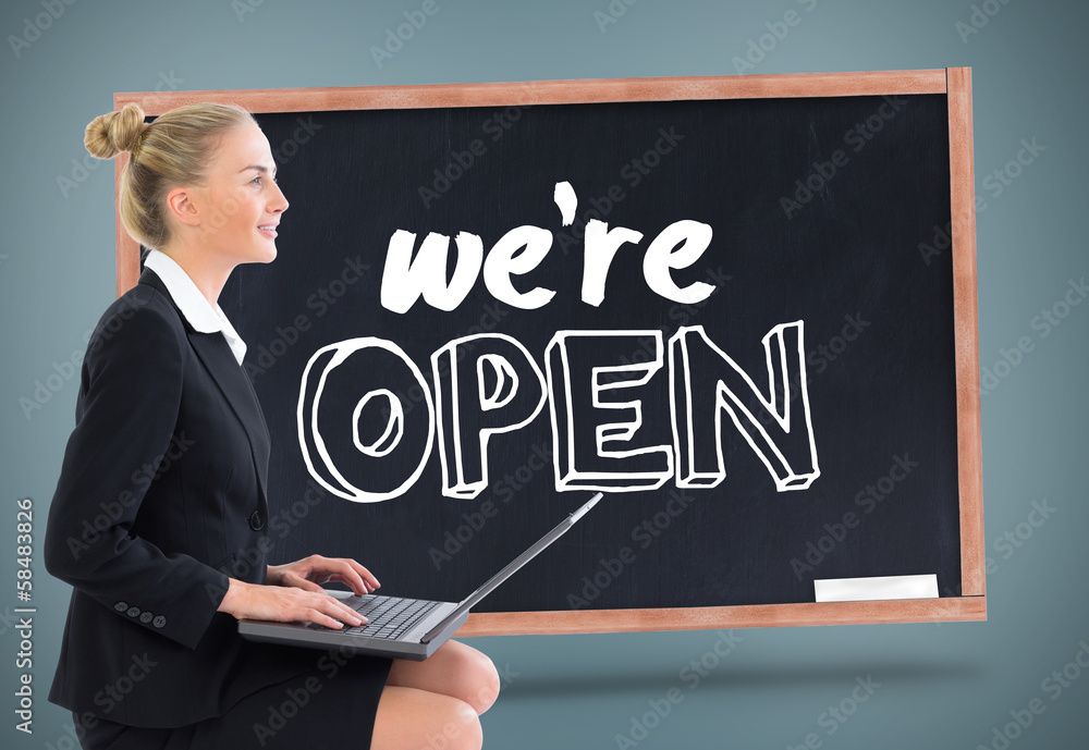 Composite image of businesswoman using laptop Composite image of businesswoman using laptop
