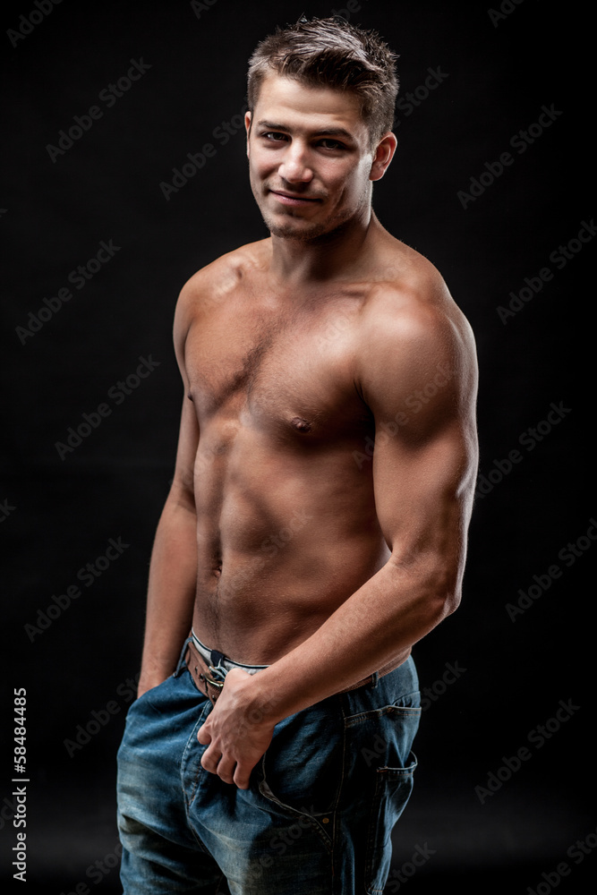 young muscular man on dark background young muscular man on dark background