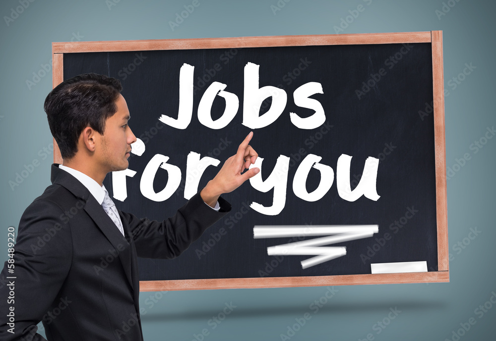 Composite image of unsmiling asian businessman pointing Composite image of unsmiling asian businessman pointing