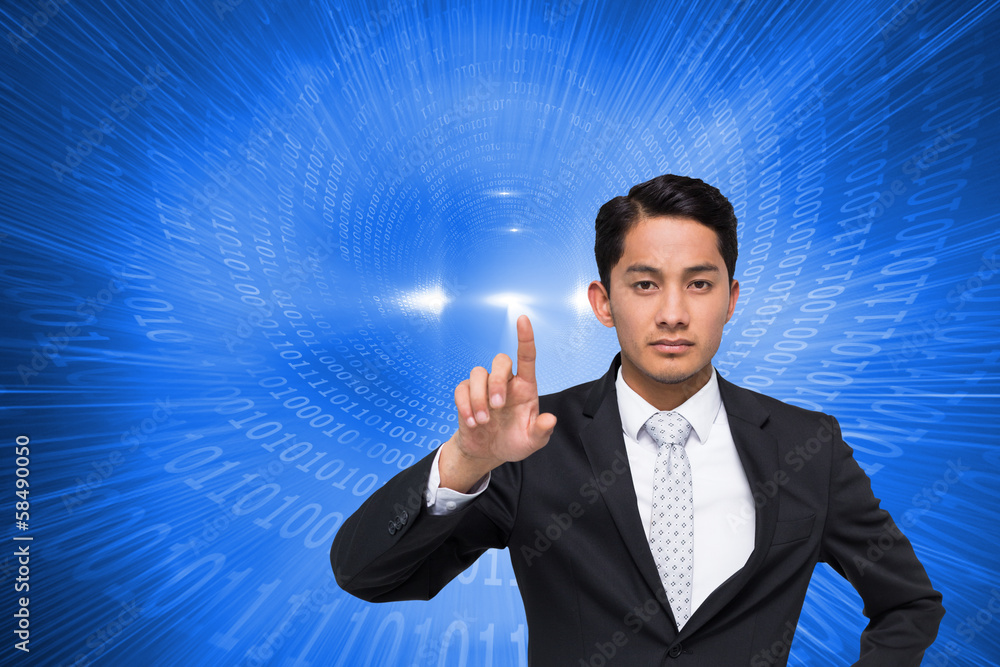 Composite image of unsmiling asian businessman pointing Composite image of unsmiling asian businessman pointing