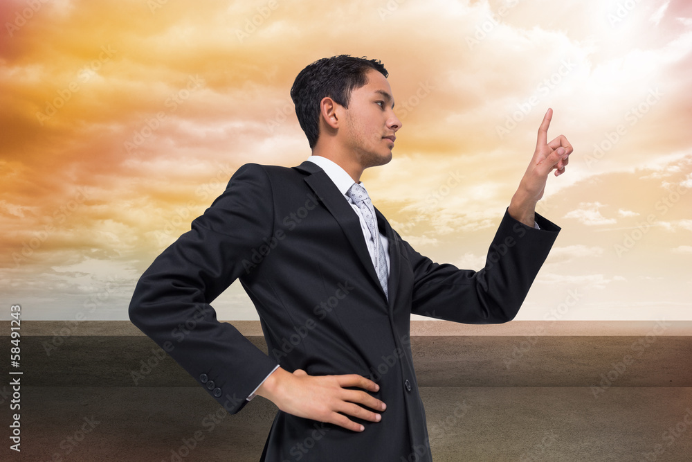 Composite image of unsmiling asian businessman pointing Composite image of unsmiling asian businessman pointing