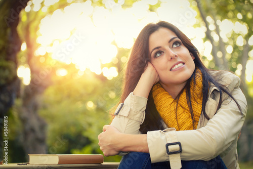 Fotografia Pensive woman day dreaming in park